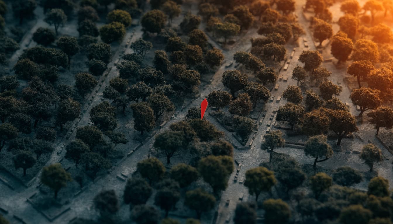 An overhead view of a miniature architectural model with trees and a red map pin.