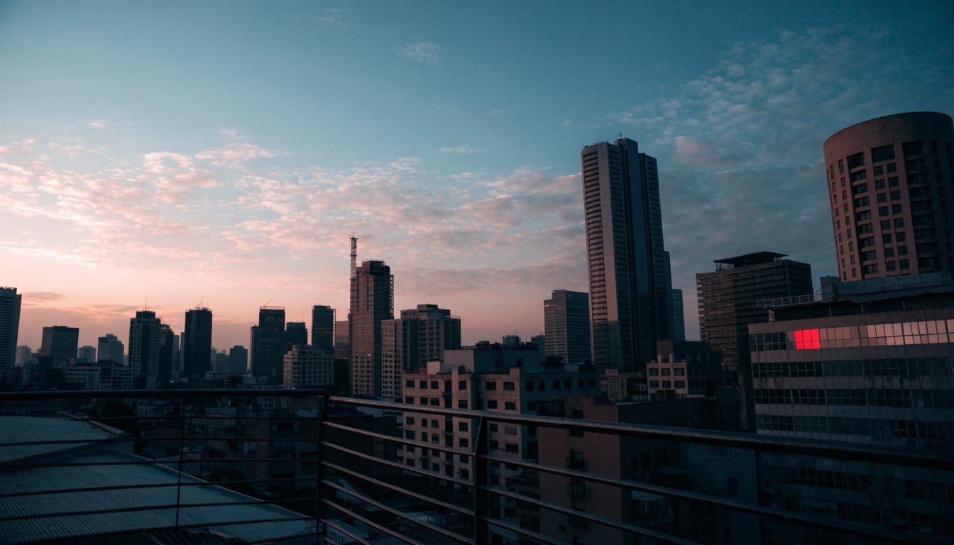 A quiet view of Nairobi's skyline at dusk with a single vivid red window.